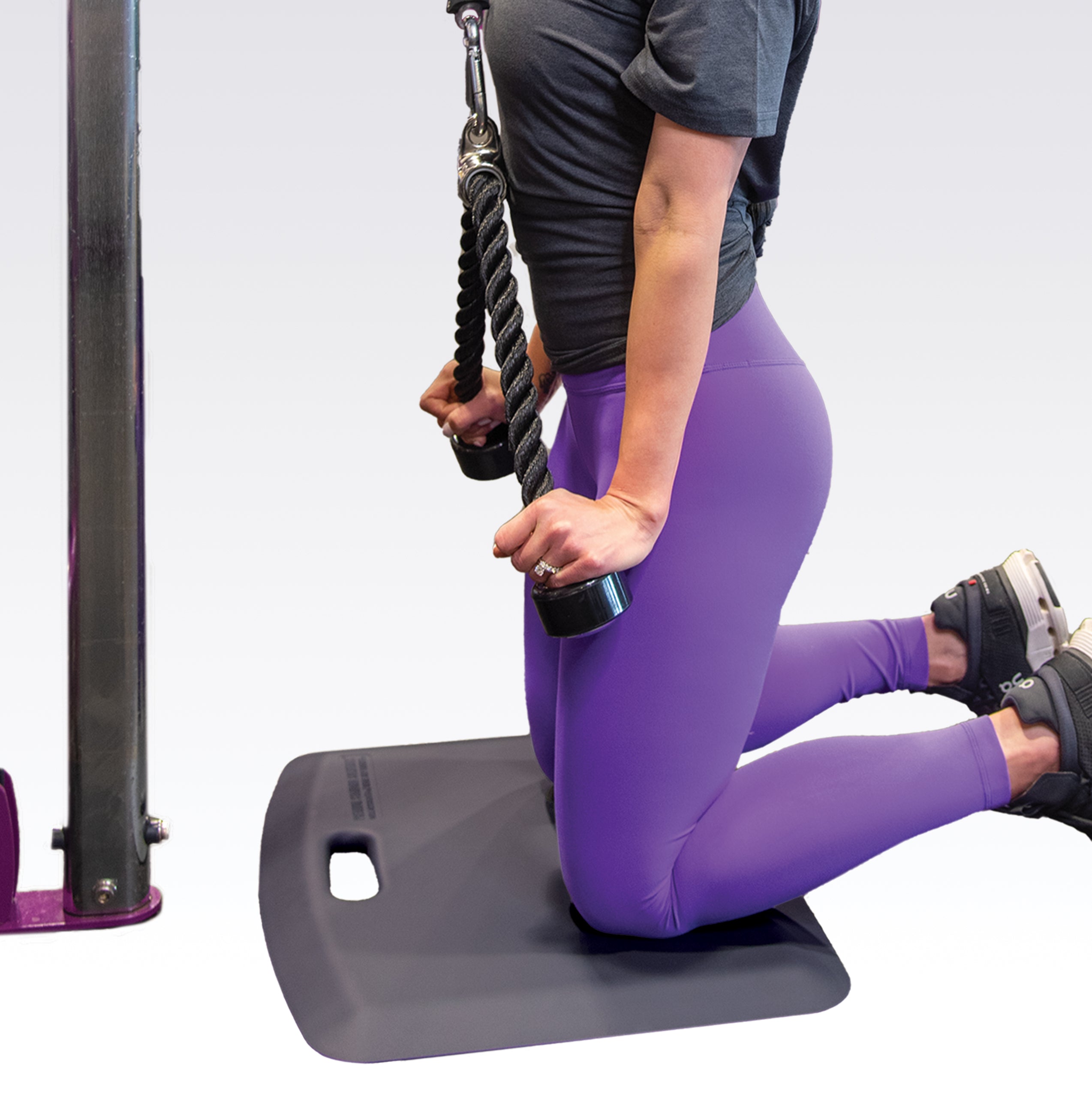 Woman doing triceps pulldowns kneeling on MobileMat.