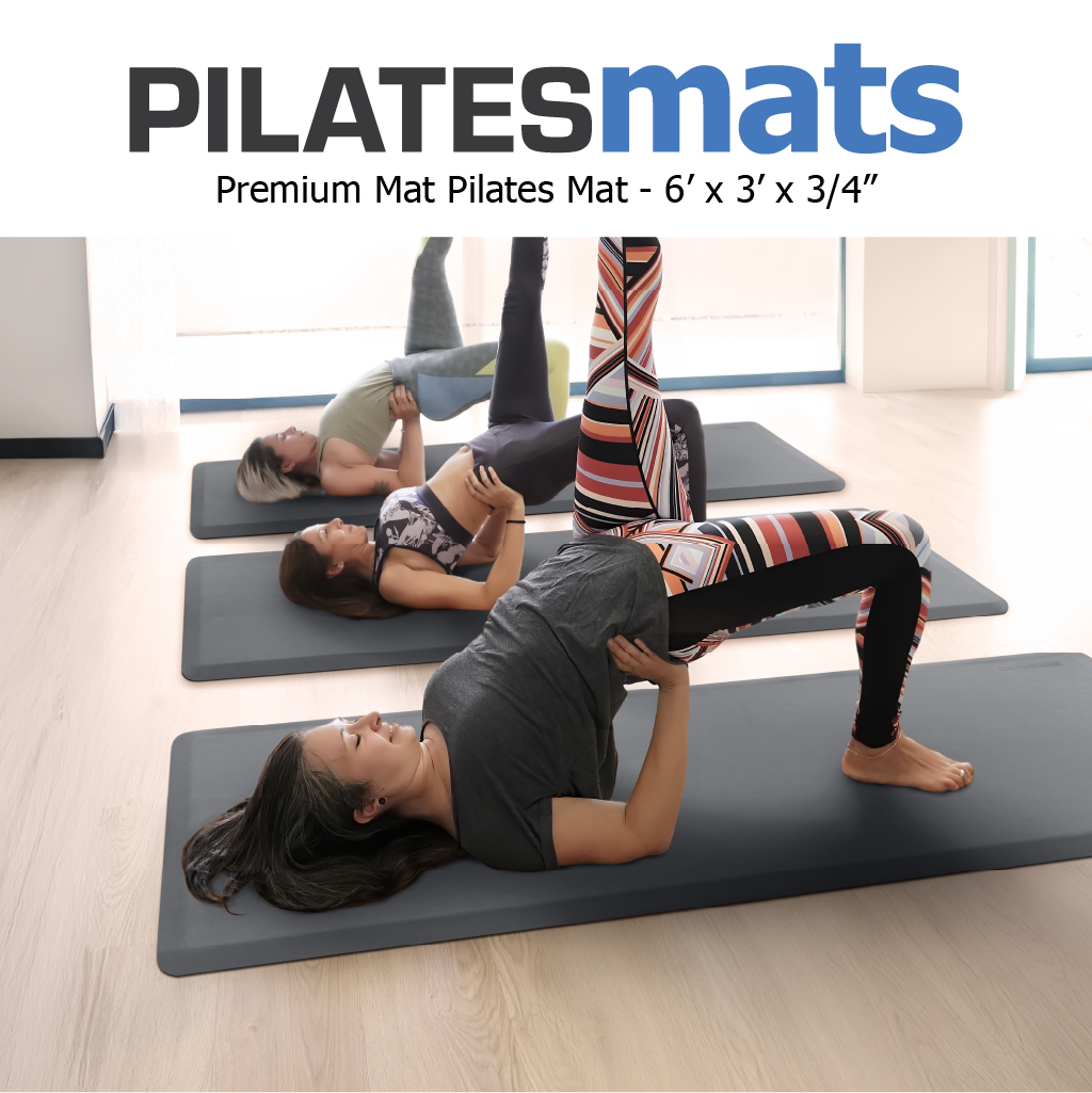Group of three women doing mat Pilates leg raise exercises on pilates mats